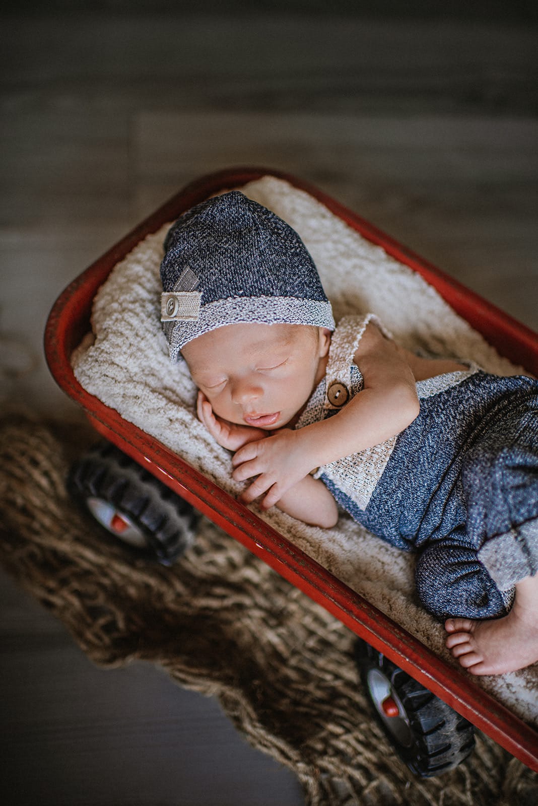 grand rapids newborn photographer baby red wagon prop.jpg
