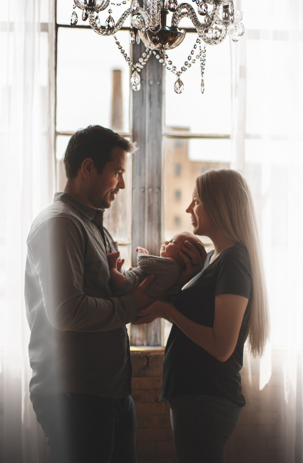 grand rapids newborn photography family window chandelier